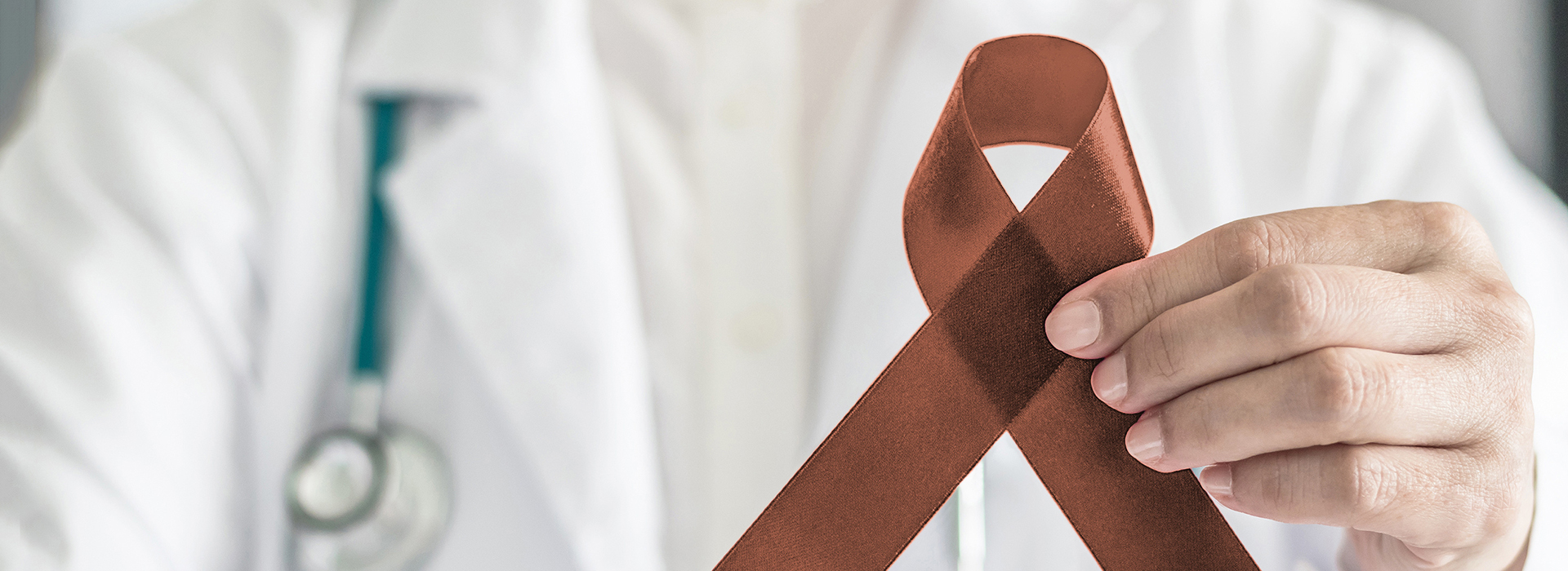 The image features a medical professional holding an AIDS awareness ribbon against a background with a hospital theme.